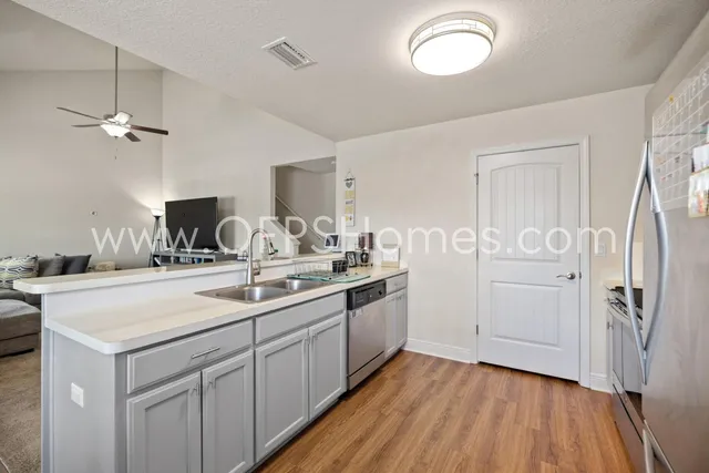 a kitchen with a sink appliances and cabinets