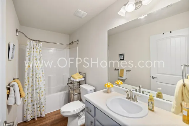 a bathroom with a sink toilet tub and shower