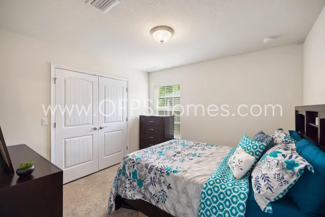 a bedroom with a bed and a cabinets