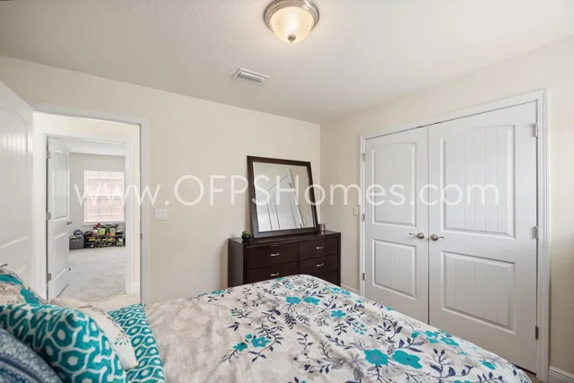 a bedroom with a bed and a dresser in it