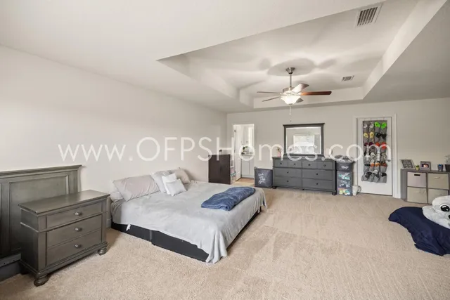 a spacious bedroom with a bed and window