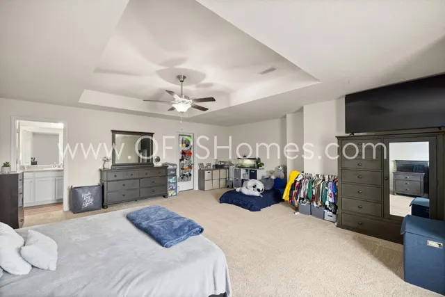 a bedroom with furniture and a large window