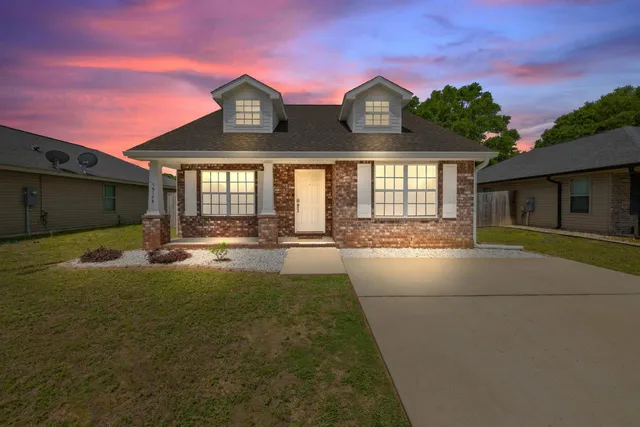 a view of house with yard in front of it