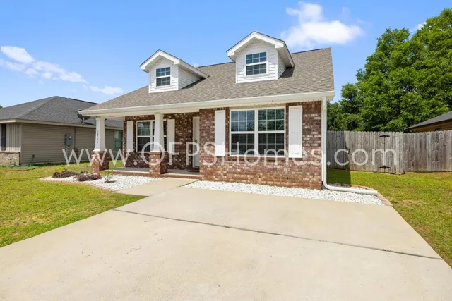 a front view of a house with swimming pool and a garden
