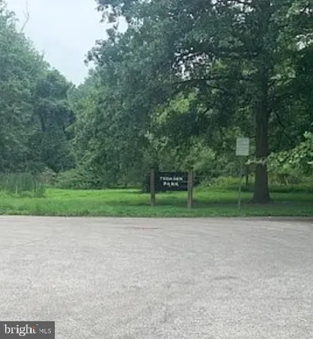 a view of outdoor space with a garden and signage