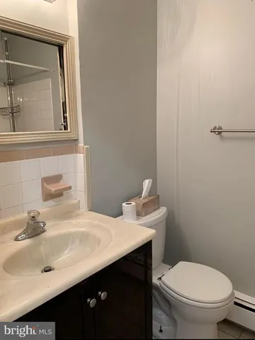 a bathroom with a sink a toilet and mirror