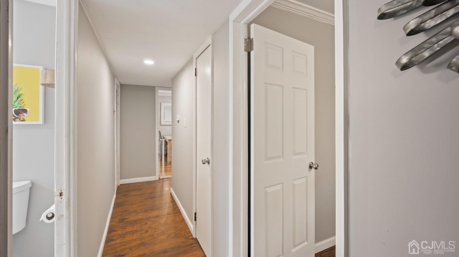 27 Melville Road Edison, NJ 08817 - Photo 7 of 14 a view of a hallway with wooden floor and a bathroom