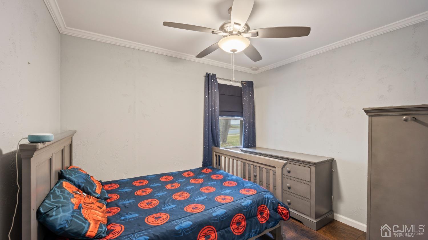 27 Melville Road Edison, NJ 08817 - Photo 8 of 14 a bedroom with a bed and a chandelier