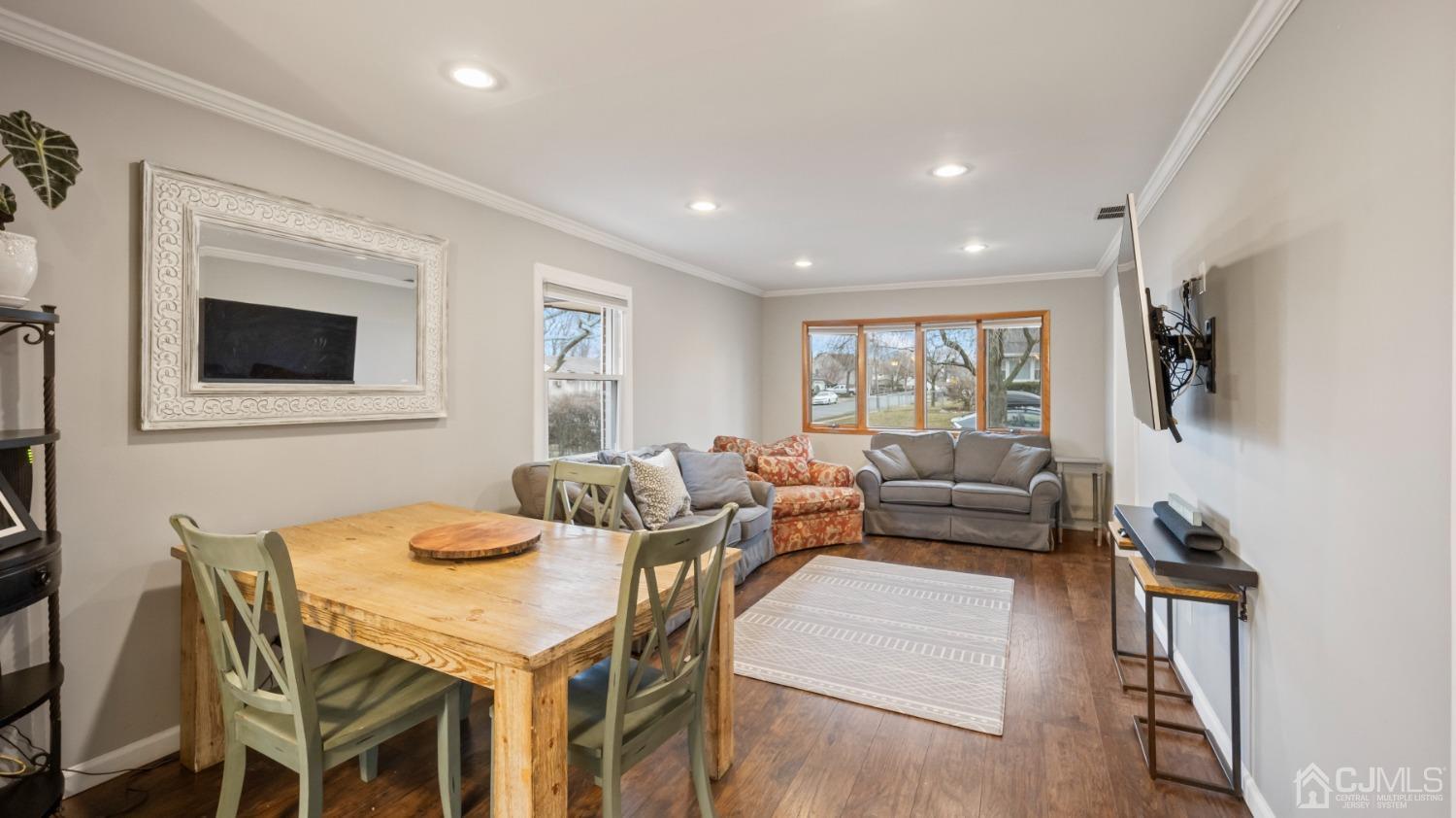 27 Melville Road Edison, NJ 08817 - Photo 10 of 14 a living room with furniture a flat screen tv and a large window