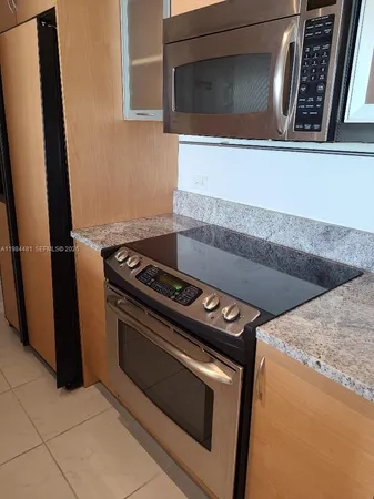 a stove top oven sitting inside of a kitchen