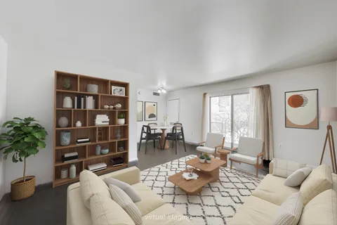 a living room with furniture and book shelf