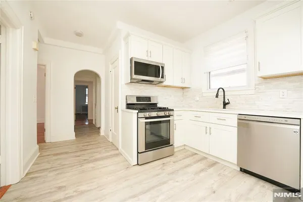 a kitchen with stainless steel appliances granite countertop a stove and a sink