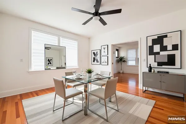 a view of a dining room with furniture and wooden floor