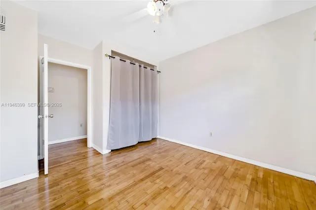 a view of a room with wooden floor
