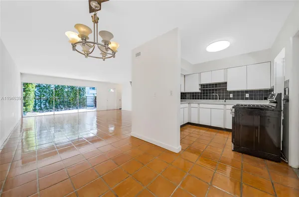 a kitchen with stainless steel appliances granite countertop a stove a sink dishwasher and a refrigerator with cabinets