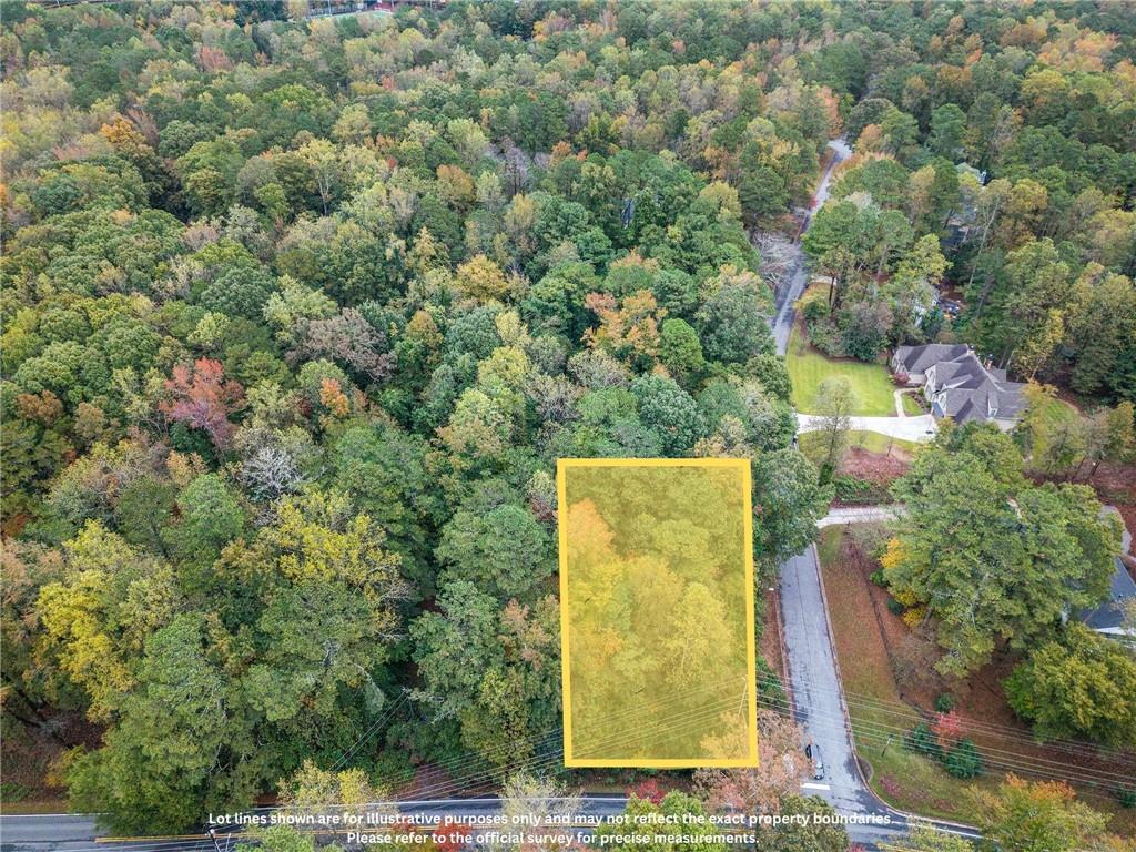 a view of a wall with a bench and trees