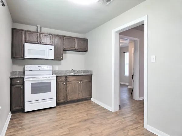 a kitchen with stainless steel appliances granite countertop a stove and a sink