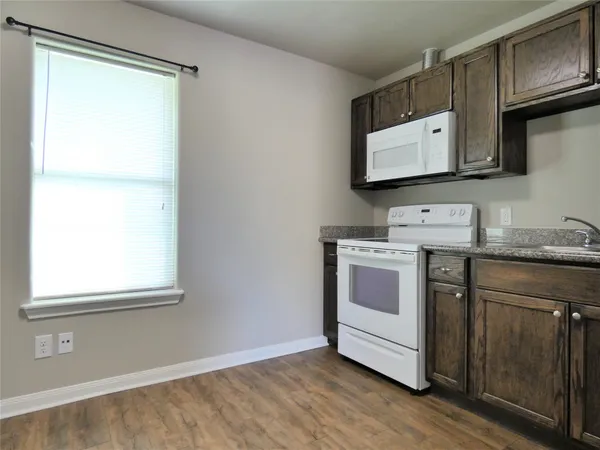 a view of cabinets and wooden floor