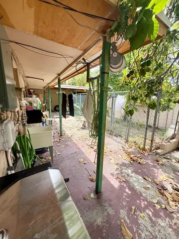 a view of a patio with a table and chairs and potted plants