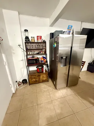a kitchen with a refrigerator and a stove top oven