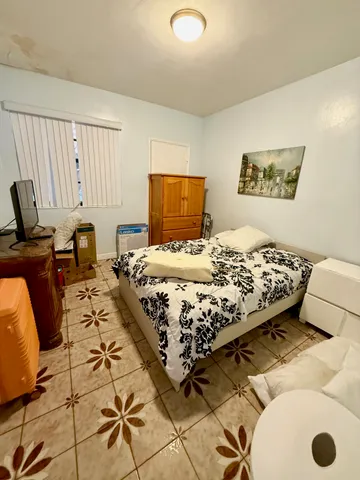 a bedroom with a bed and a chair