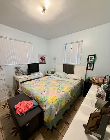 a bedroom with bed and a couch