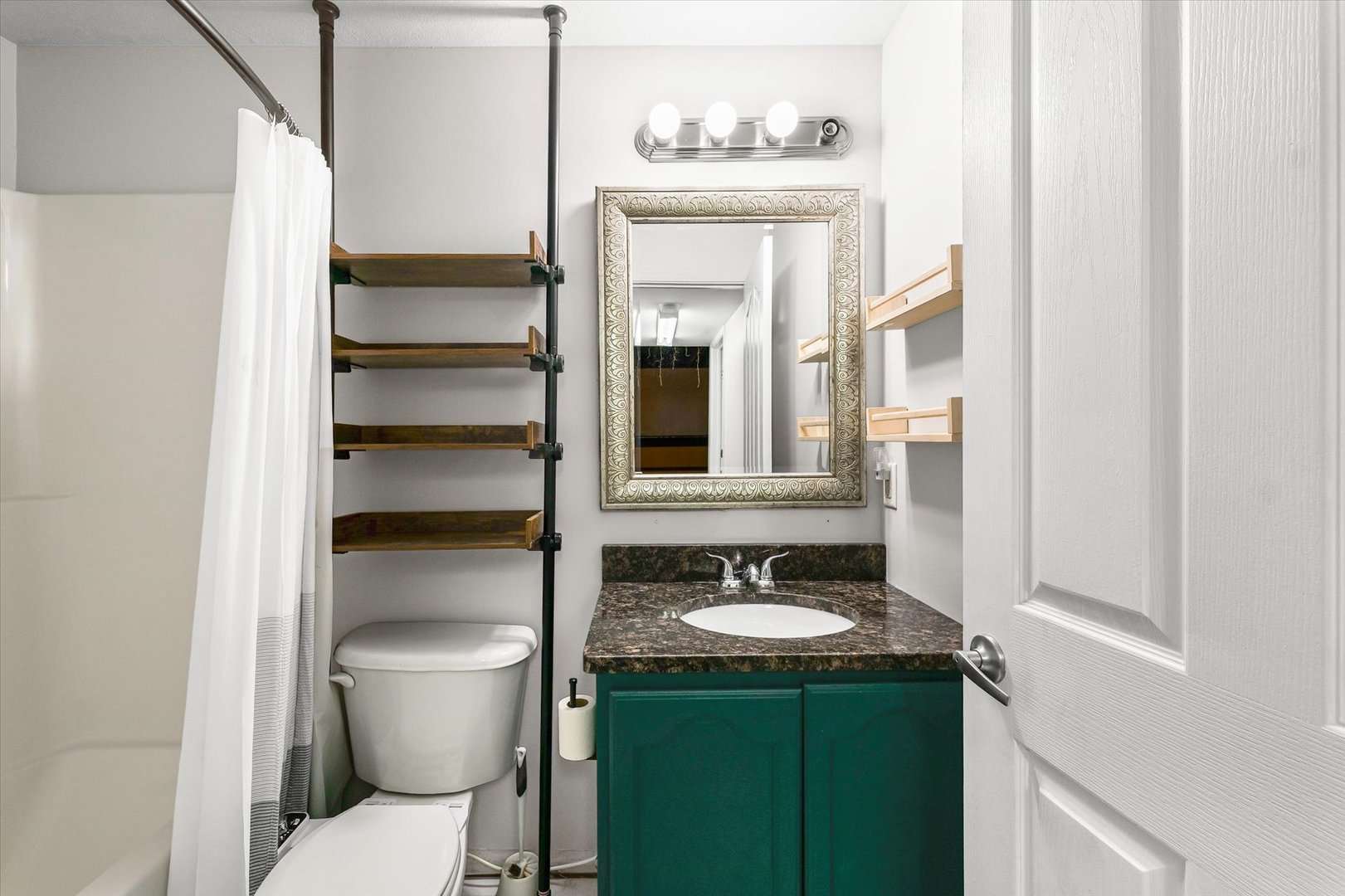 3725 Boulder Ridge Drive, Unit E Champaign, IL 61822 - Photo 26 of 30 a bathroom with a sink vanity mirror and toilet