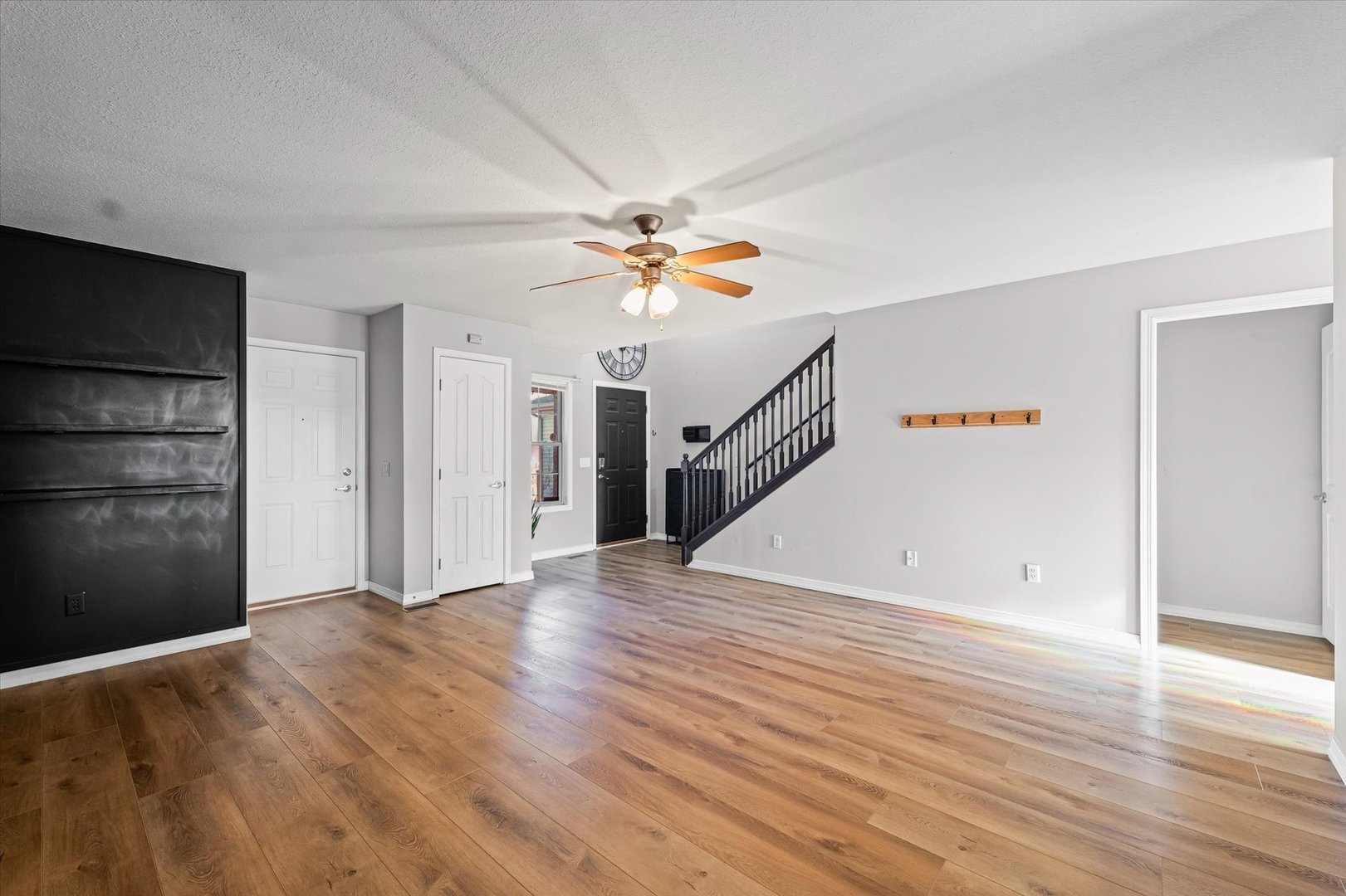 3725 Boulder Ridge Drive, Unit E Champaign, IL 61822 - Photo 6 of 30 an empty room with wooden floor ceiling fan