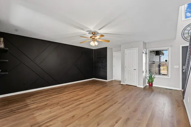 a view of an empty room with wooden floor