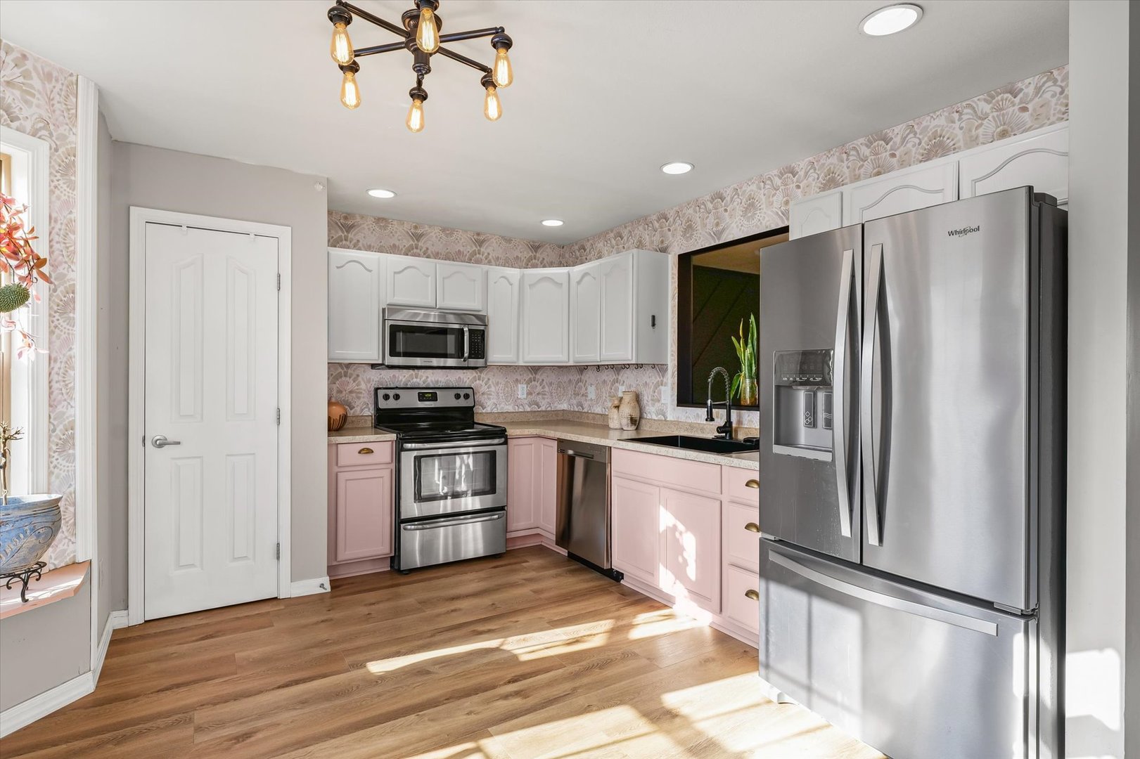3725 Boulder Ridge Drive, Unit E Champaign, IL 61822 - Photo 9 of 30 a kitchen with granite countertop stainless steel appliances a refrigerator cabinets and wooden floor