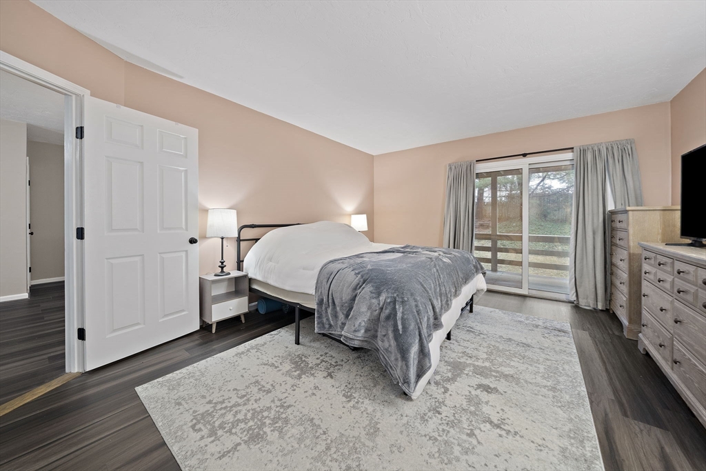 22 Union Square, Unit 22 Randolph, MA 02368 - Photo 21 of 28 a bedroom with a bed and a flat tv screen on dresser