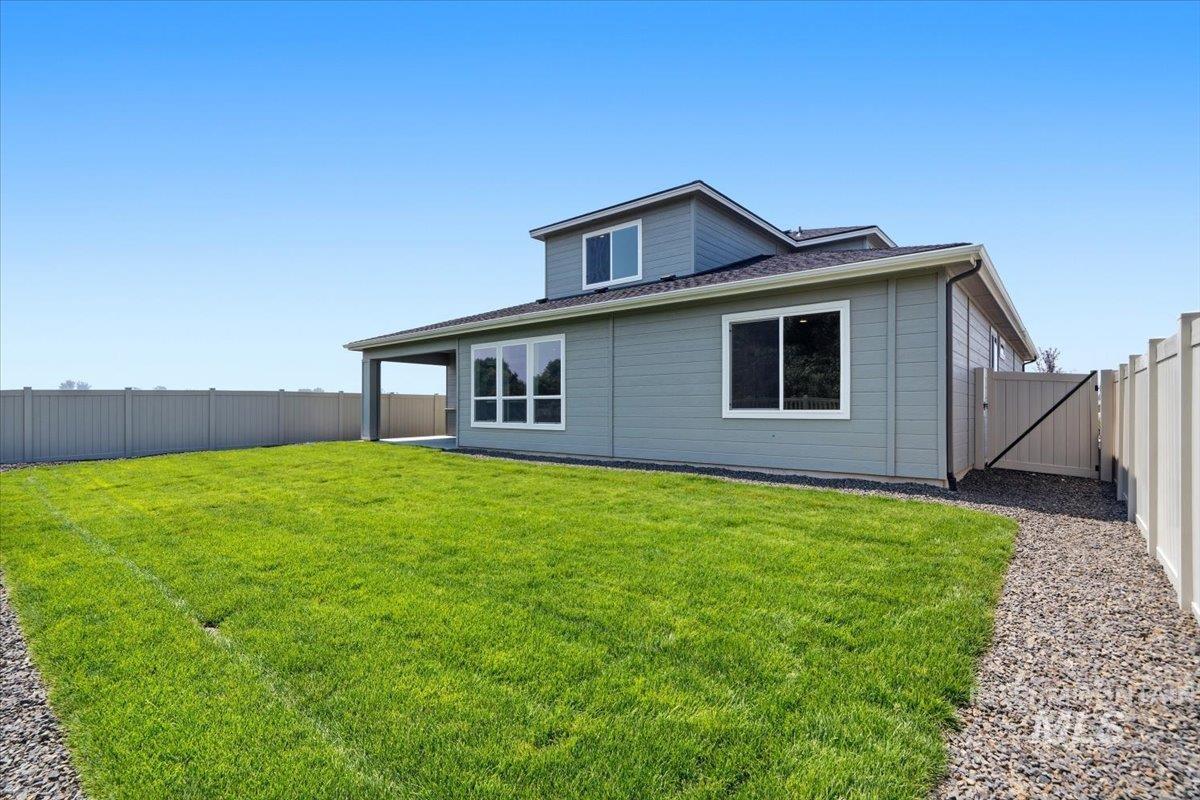 4317 Tropic Way Caldwell, ID 83607 - Photo 42 of 47 Expansive backyard featuring a manicured lawn, full perimeter fencing, and a covered patio area