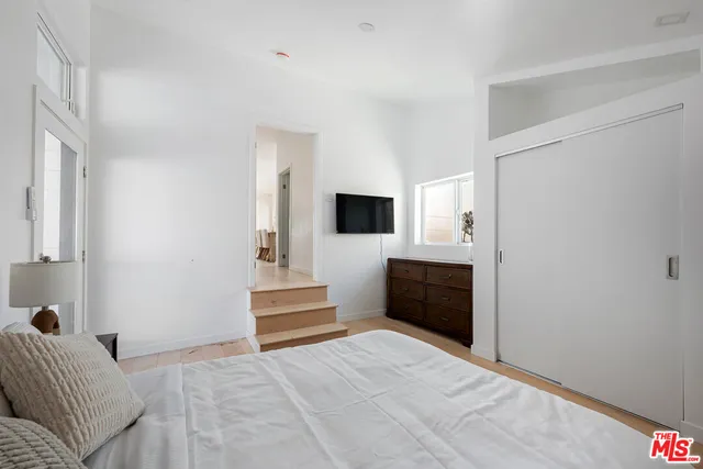 a bedroom with a bed and a television