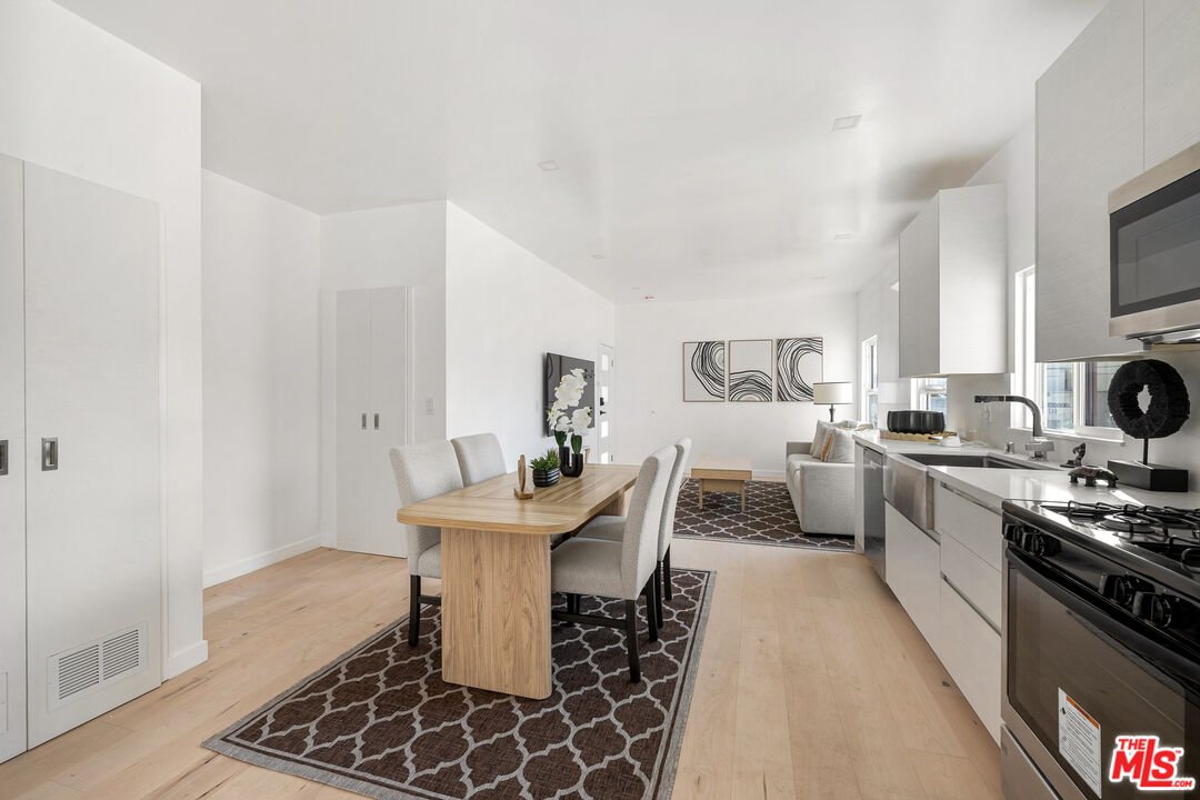 117 West Channel Road, Unit 115 Santa Monica, CA 90402 - Photo 6 of 11 a kitchen with a sink and white appliances