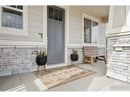 a backyard of a house with barbeque oven and outdoor seating