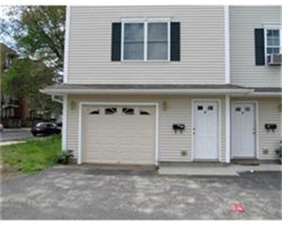 153-159 White Street Springfield, MA 01108 - Photo 3 of 8 a front view of a house with a yard and garage