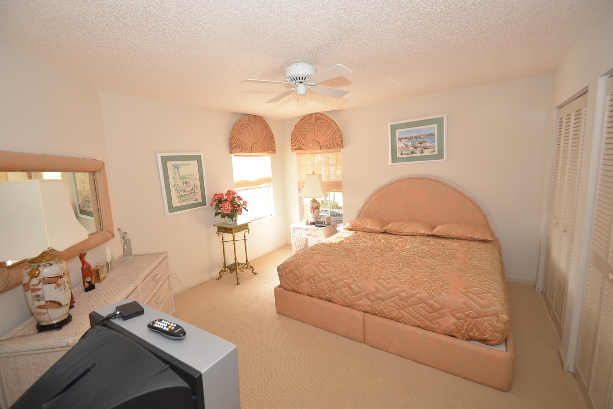 6390 Northwest 24th Avenue Boca Raton, FL 33496 - Photo 15 of 32 a bedroom with a bed and a chandelier