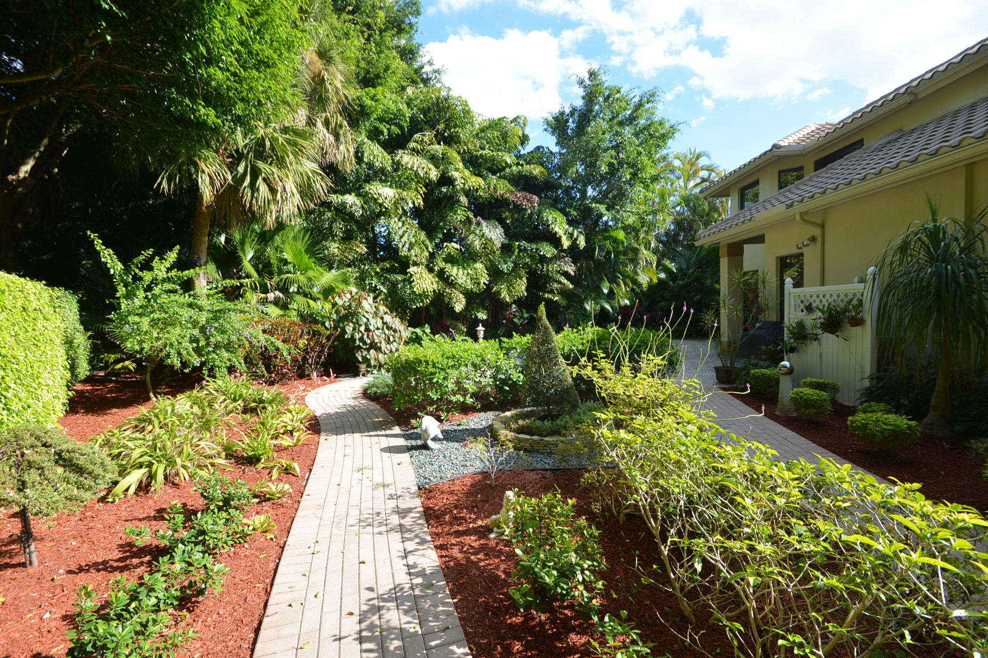 6390 Northwest 24th Avenue Boca Raton, FL 33496 - Photo 30 of 32 a backyard of a house with a garden