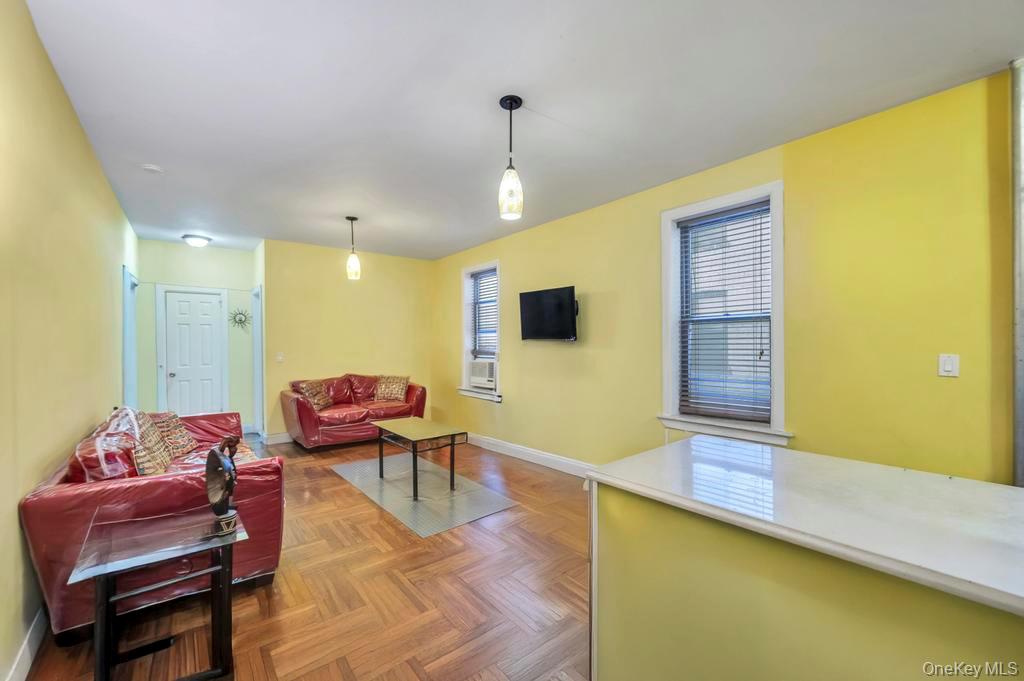 2020 East 41st Street, Unit 2B Brooklyn, NY 11234 - Photo 11 of 17 a living room with furniture and a flat screen tv