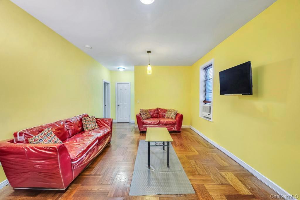 2020 East 41st Street, Unit 2B Brooklyn, NY 11234 - Photo 12 of 17 a living room with furniture and a flat screen tv