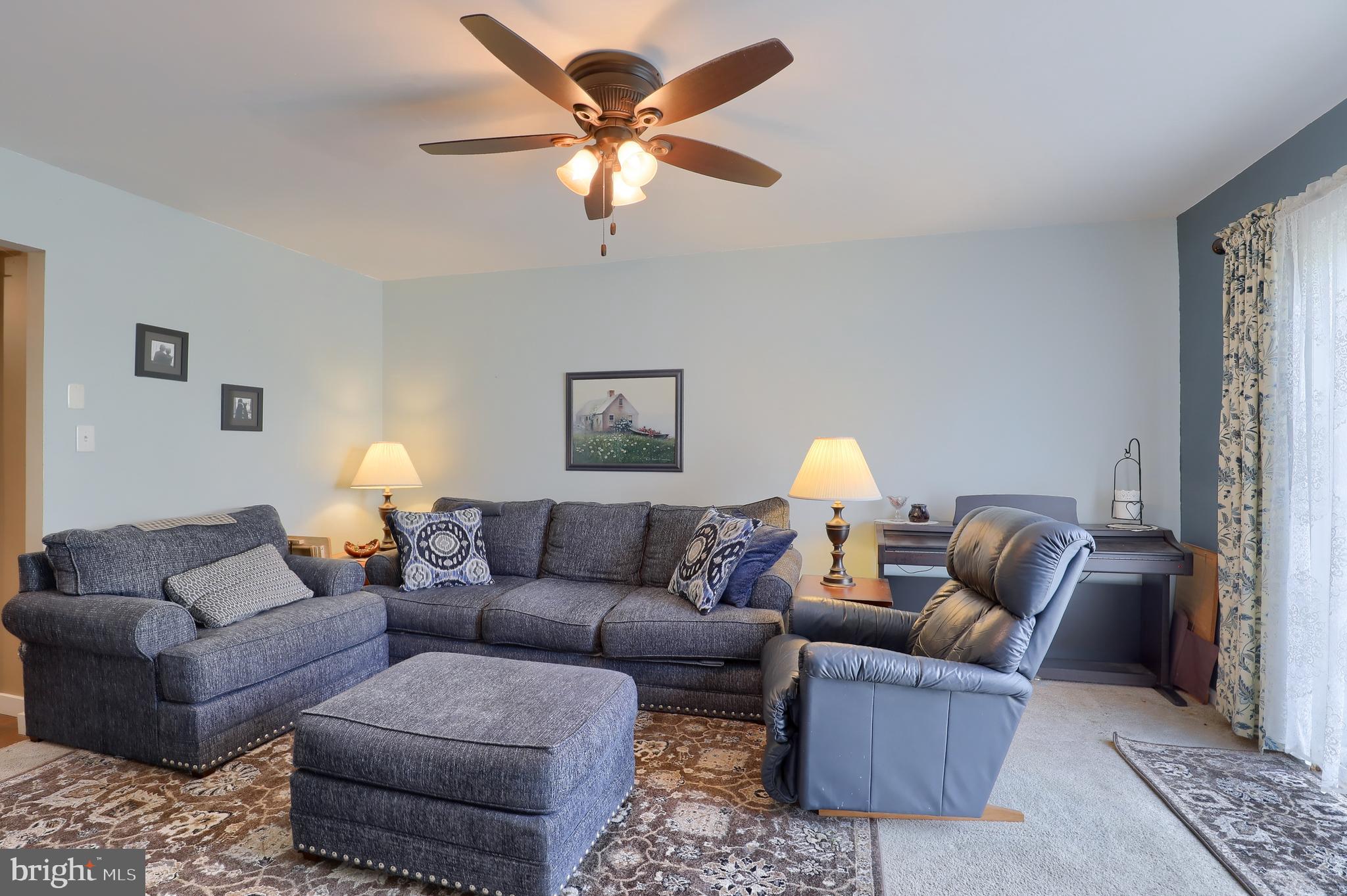465 Crosswinds Drive Lititz, PA 17543 - Photo 15 of 30 a living room with furniture a lamp and a chandelier