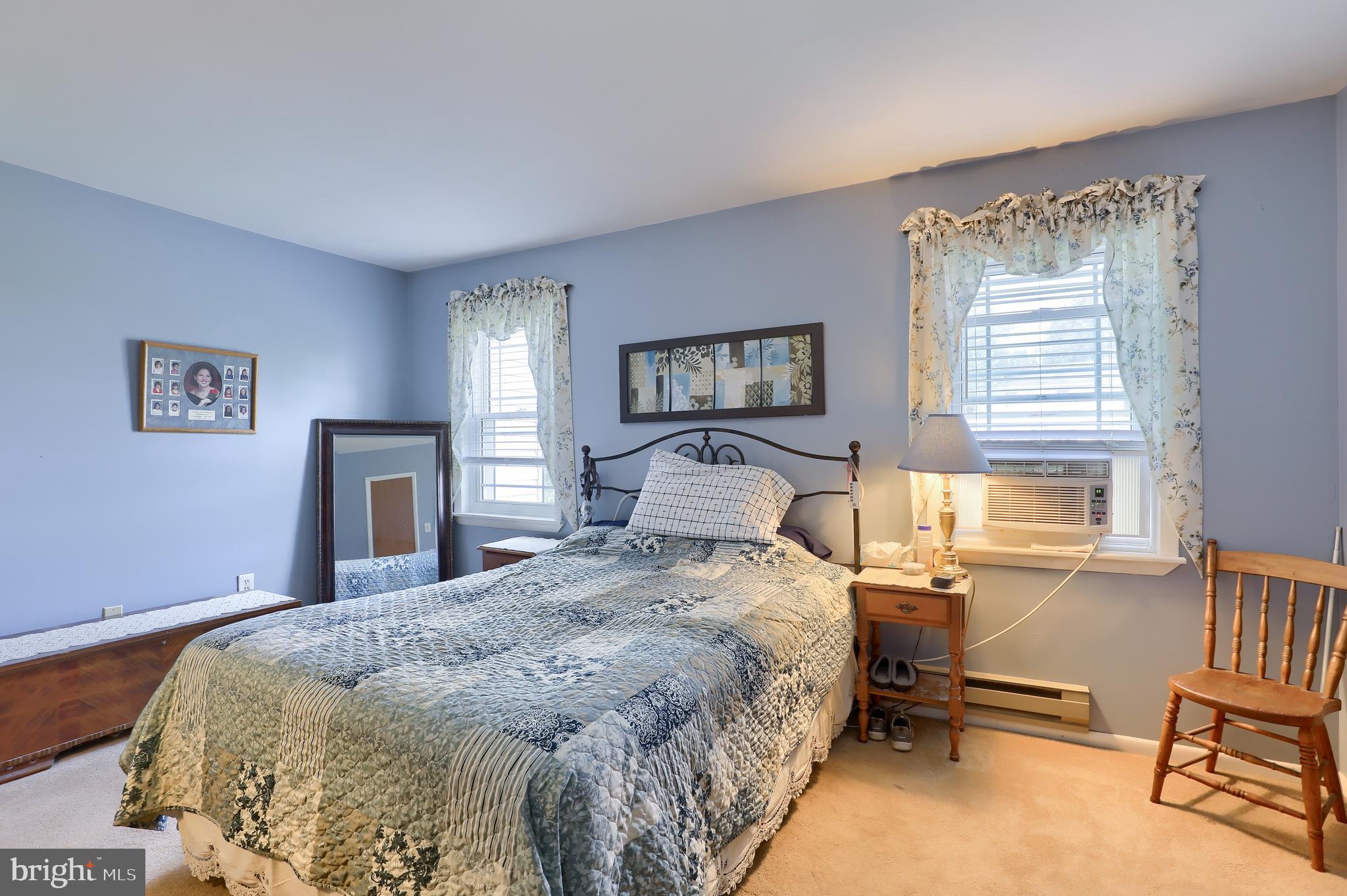 465 Crosswinds Drive Lititz, PA 17543 - Photo 21 of 30 a bedroom with a bed wooden floor and a large window