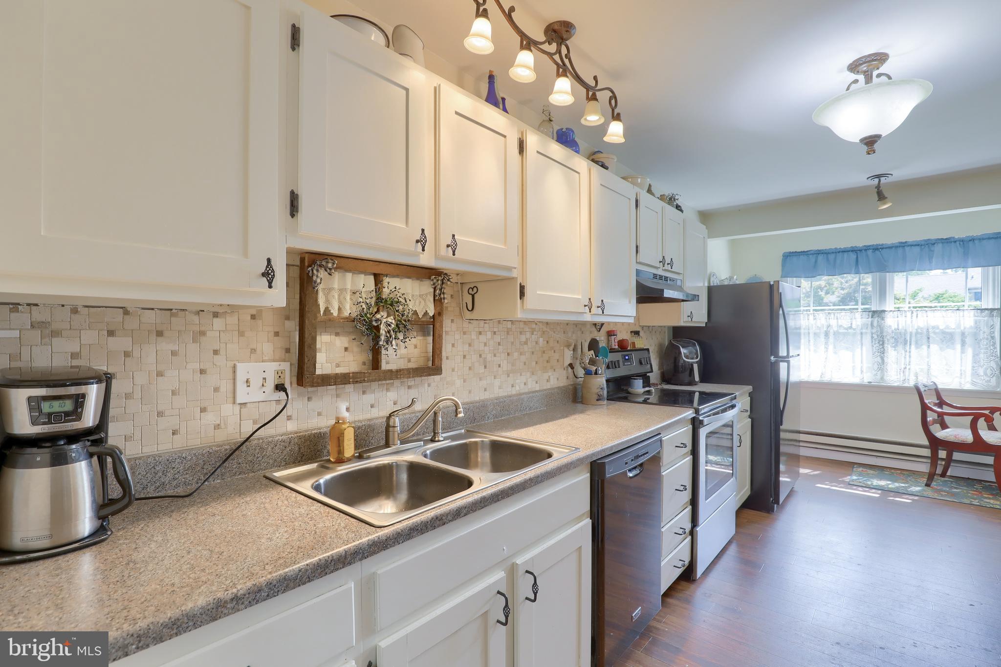 465 Crosswinds Drive Lititz, PA 17543 - Photo 5 of 30 a kitchen that has a lot of cabinets stainless steel appliances and a counter space
