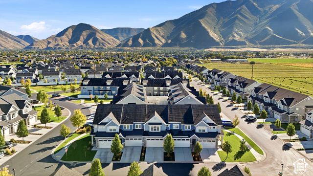 1081 Bowery Way Mapleton, UT 84664 - Photo 36 of 41 Residential community with mountain backdrop, featuring multiple single-family residences and townhomes, landscaped common areas, and paved roadways