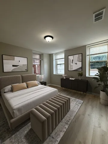 a bedroom with a large bed and a couch