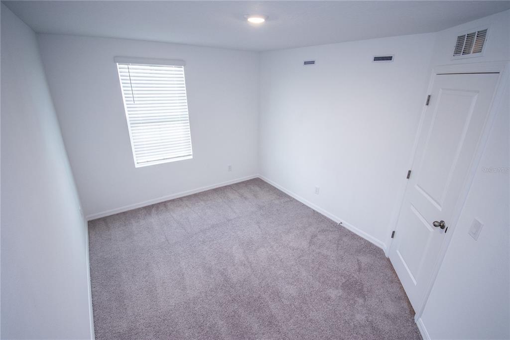 947 Conch Road Davenport, FL 33896 - Photo 12 of 20 an empty room with a window