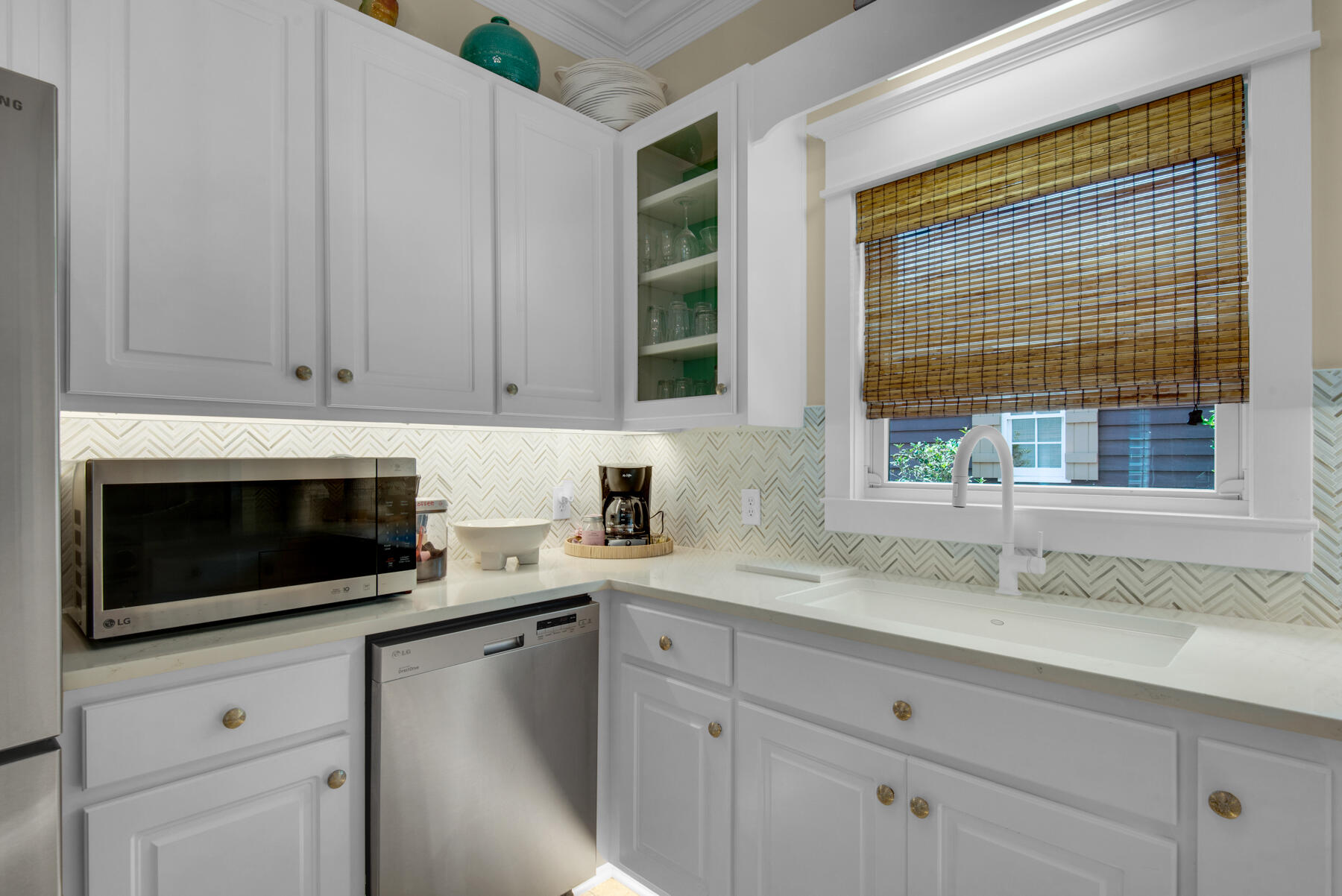 61 Rue Caribe Miramar Beach, FL 32550 - Photo 16 of 69 a kitchen with granite countertop a sink stainless steel appliances white cabinets and a window