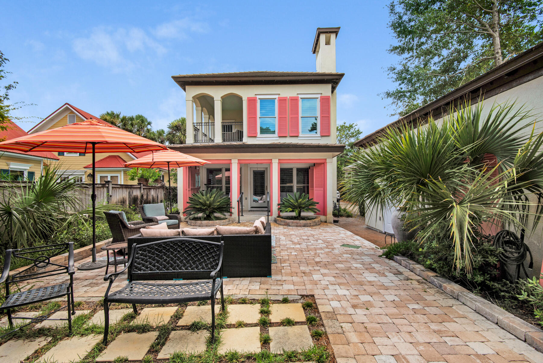 61 Rue Caribe Miramar Beach, FL 32550 - Photo 46 of 69 a patio with a table and chairs under an umbrella