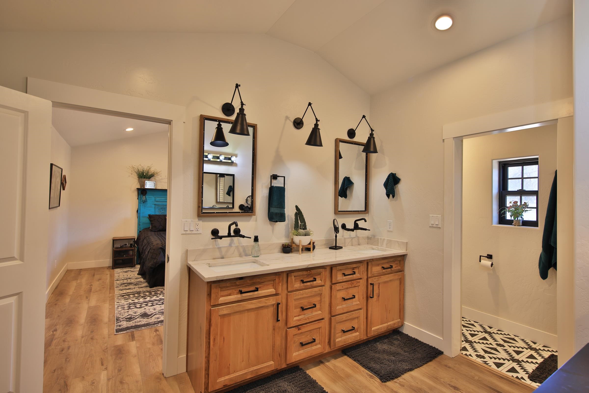 58749 Oe Road Collbran, CO 81624 - Photo 16 of 42 a spacious bathroom with a double vanity sink a mirror and a shower