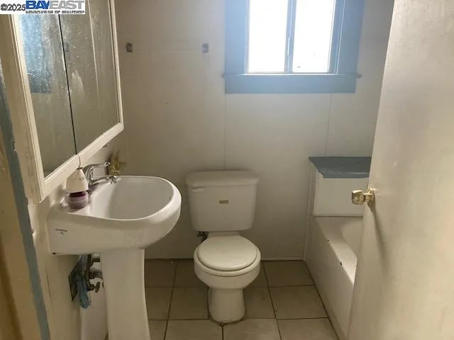 a bathroom with a sink toilet and a mirror